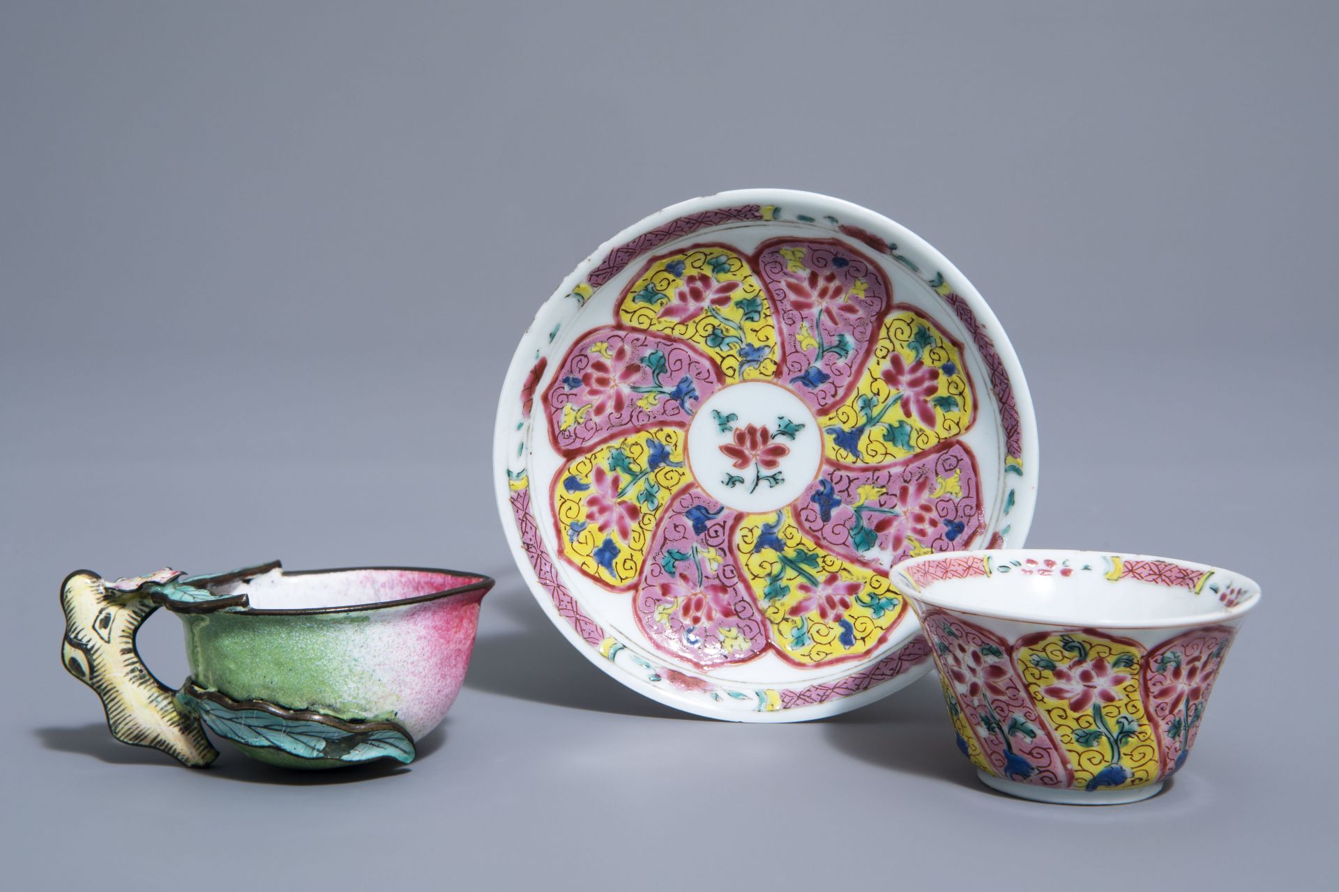 A Chinese famille rose cup and saucer and a Canton enamel peach shaped cup, Yongzheng/Qianlong