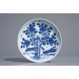 A Chinese blue and white dish with peacocks near blossoms, marked 'Tian lu fu gui jia qi', Wanli
