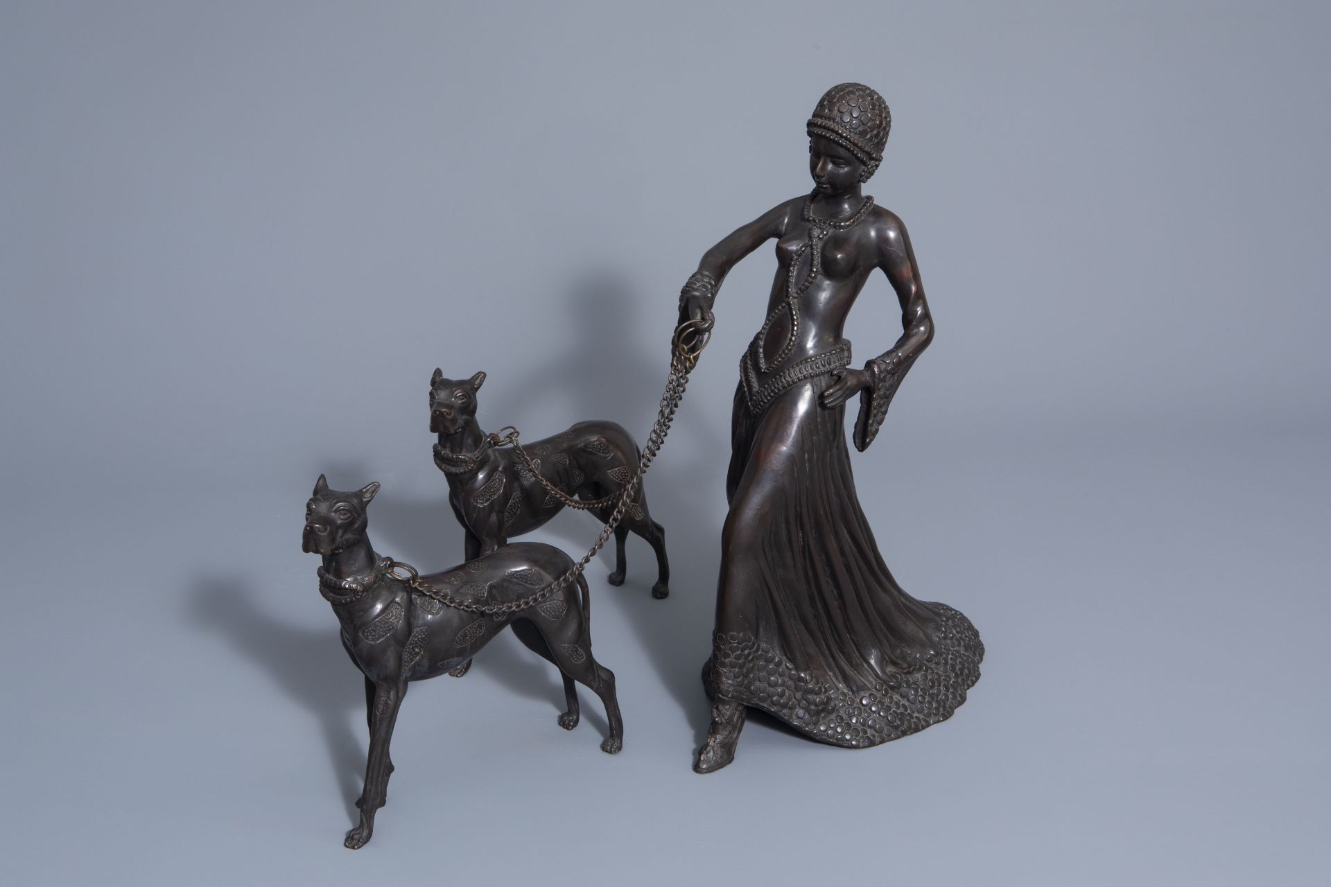 In the manner of Demetre Chiparus (1886-1947): Lady with two dogs, patinated bronze