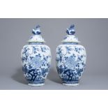 A pair of large Dutch Delft blue and white covered vases, 18th C.