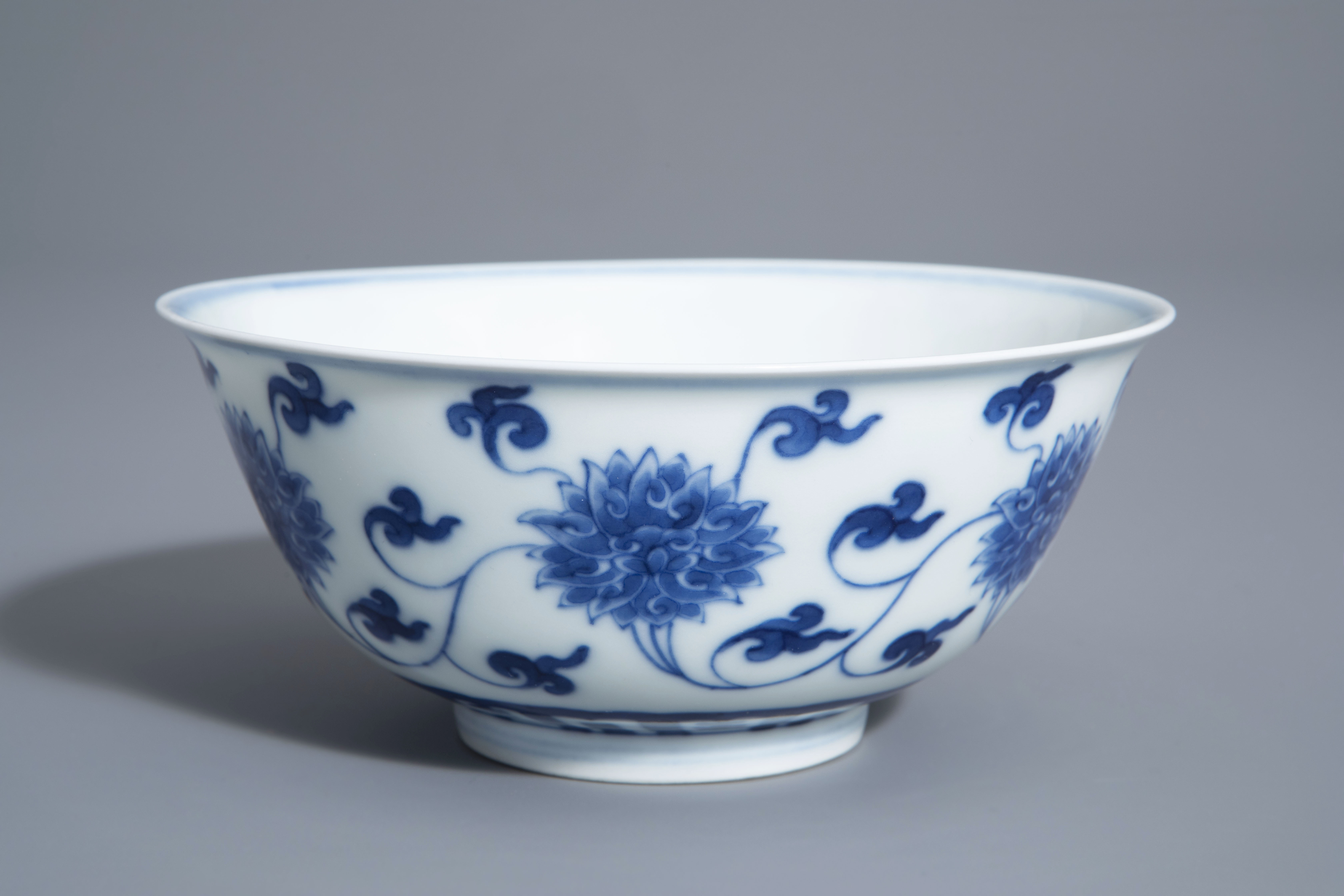 A Chinese blue and white 'lotus scroll' bowl, Kangxi mark, 19th/20th C.