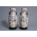 A pair of Chinese Nanking crackle glazed famille rose vases w. warrior scenes on stands, 19th C.