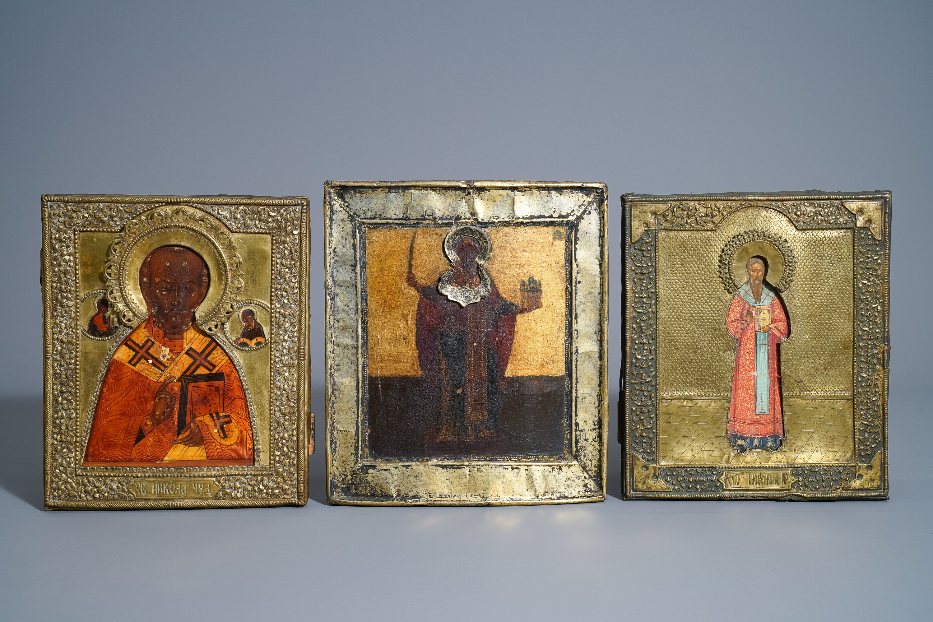 Three Russian icons, 'Saint Nicholas', with copper oklad or riza, 19th C.