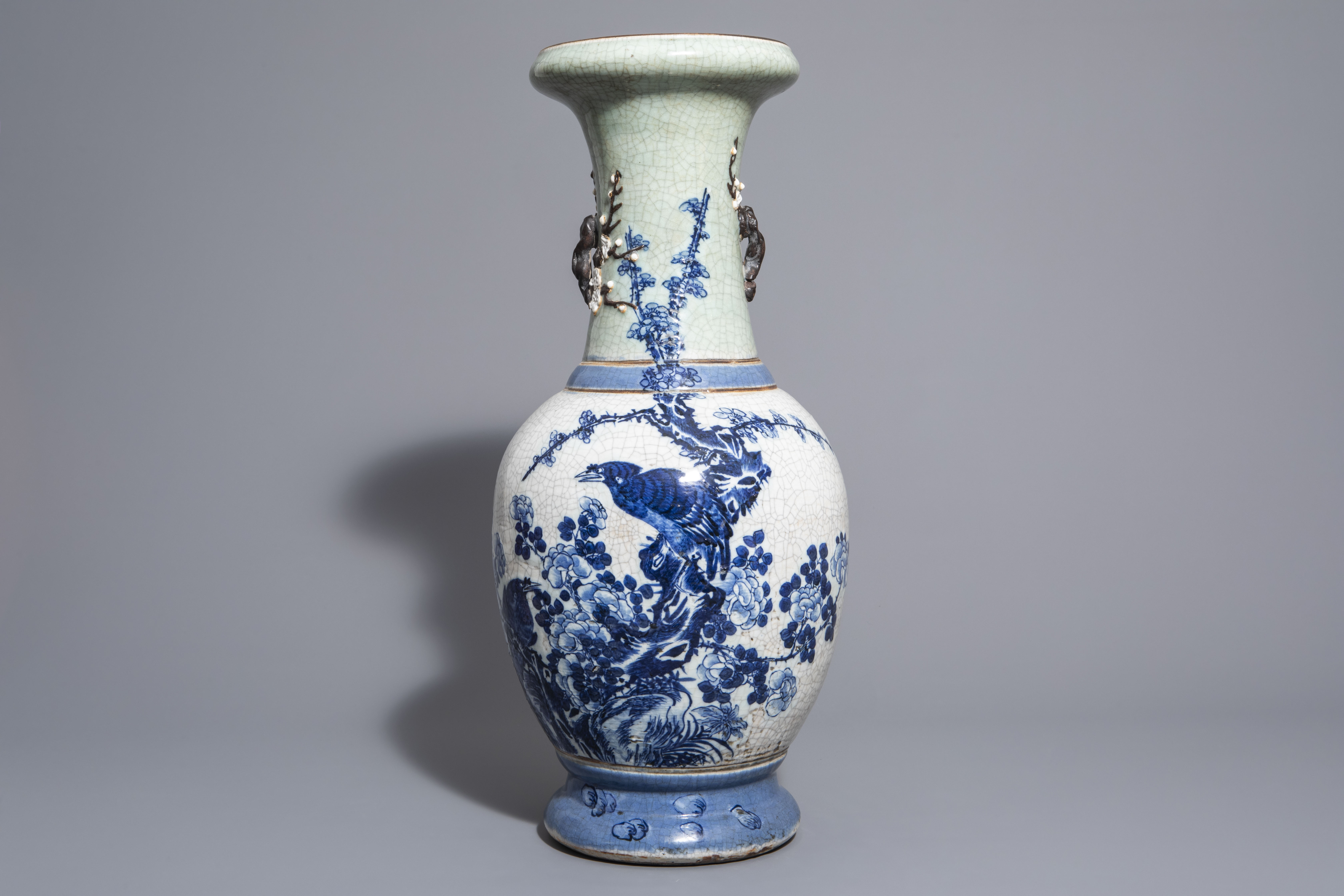 A Chinese blue and white Nanking crackle glazed vase with birds on blossoming branches, 19th C.