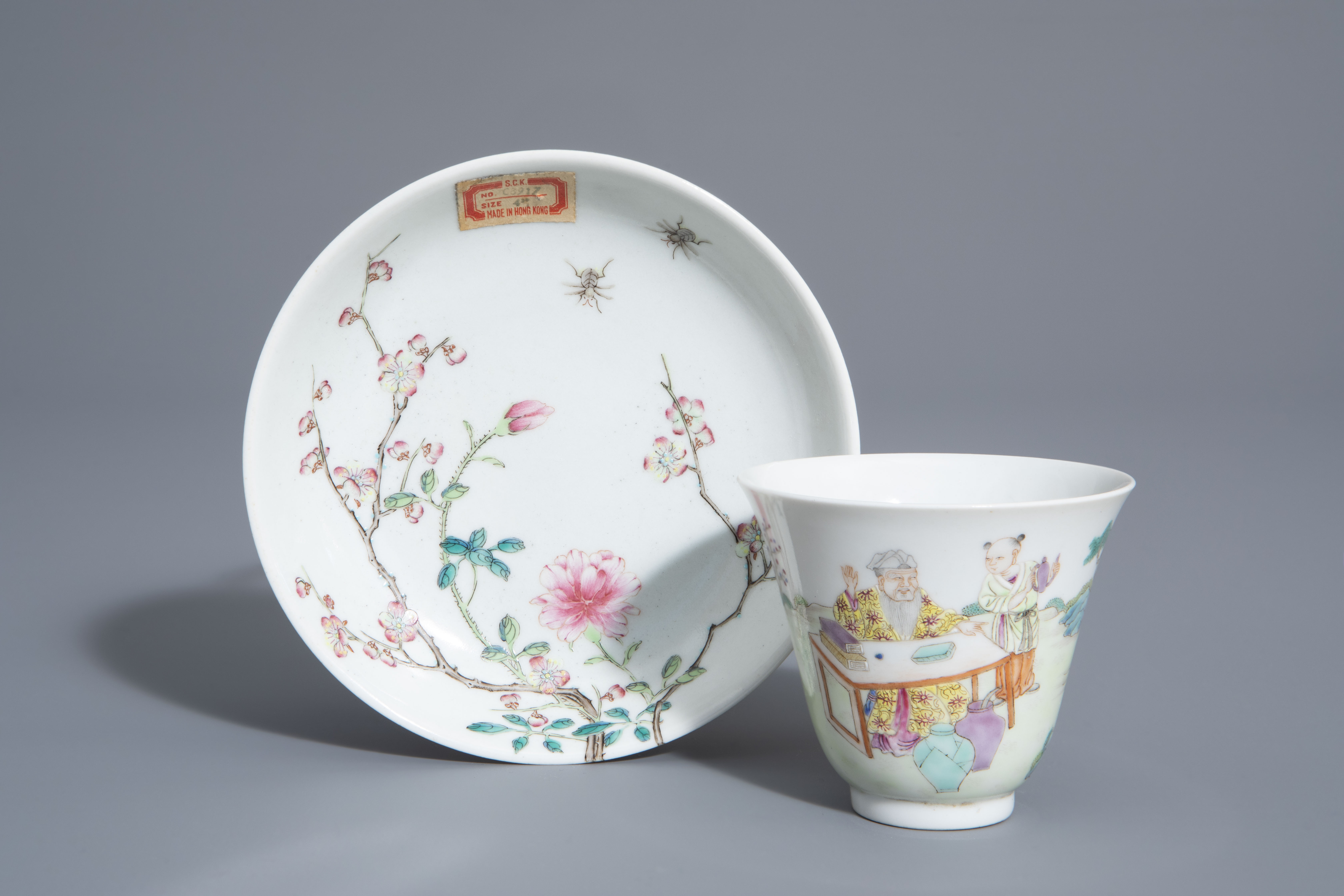 A Chinese famille rose cup and a saucer with different designs, 19th/20th C.