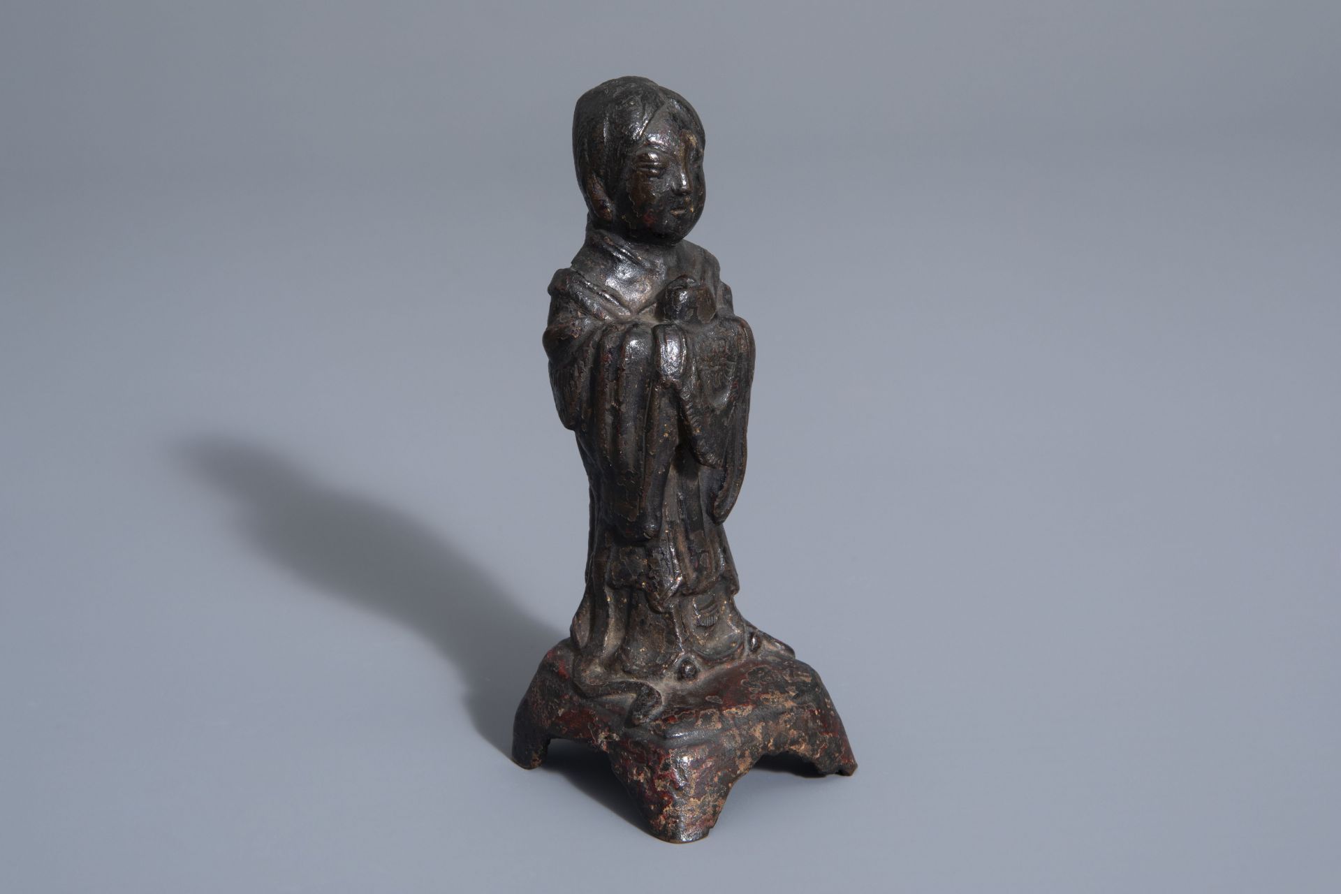 A Chinese bronze figure of a standing lady, Ming