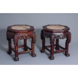 A pair of Chinese carved wood stands with marble tops, 20th C.