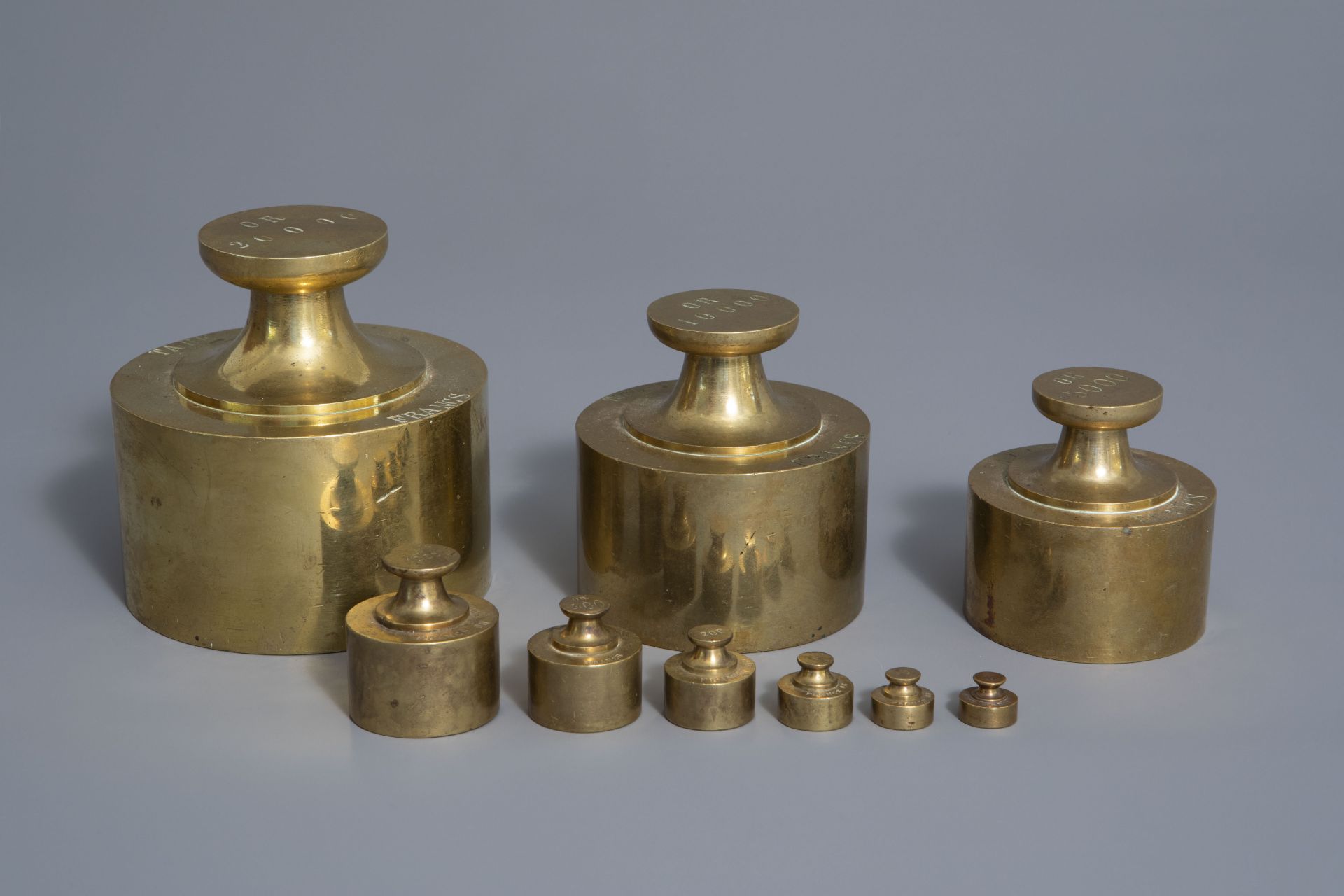 A French nine-piece set of copper bank weights for gold coins, 19th C.