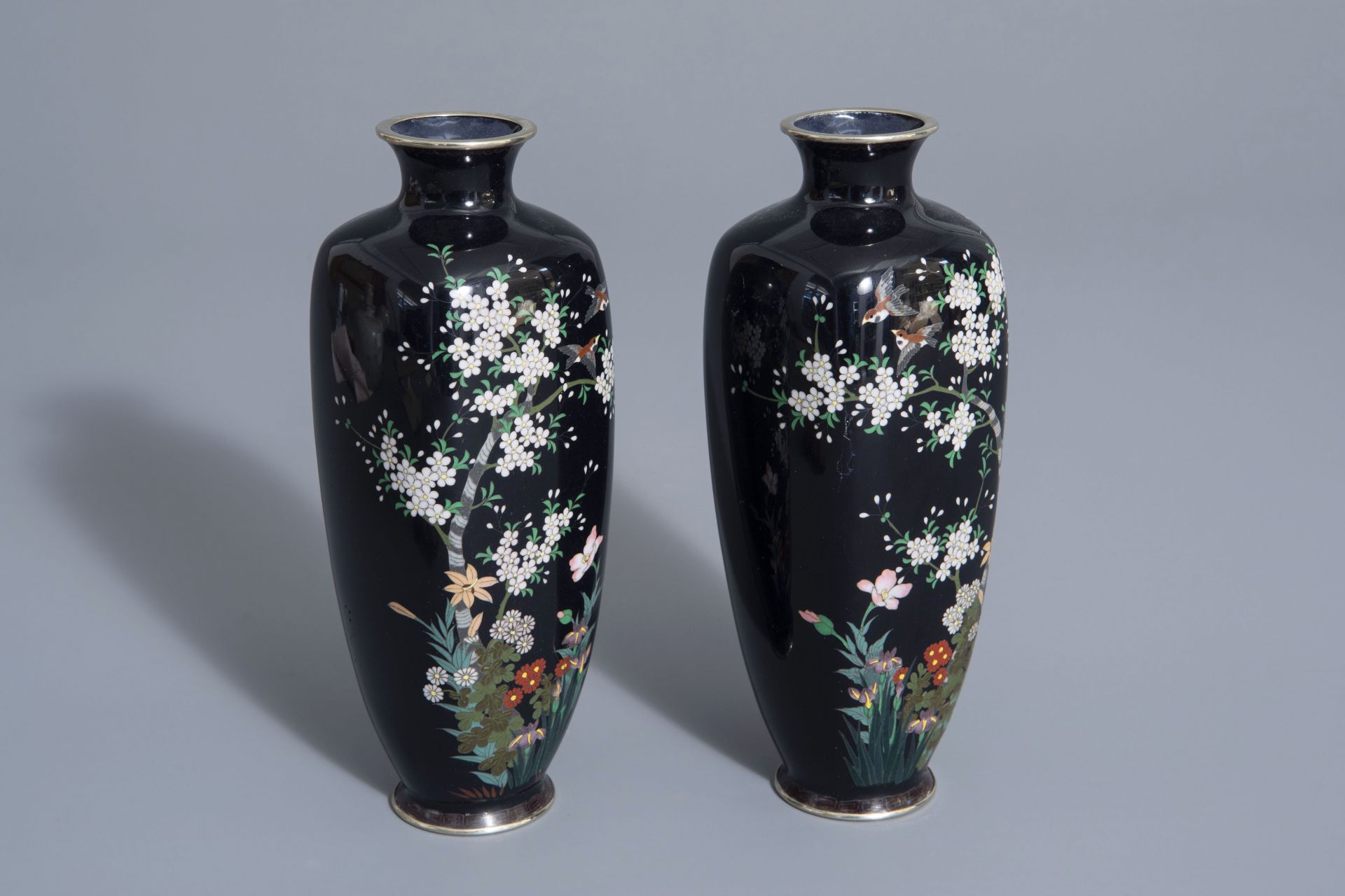 A pair of Japanese cloisonné vases with birds among blossoming branches, Meiji, 19th/20th C.