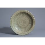 A Chinese Longquan celadon dish with incised floral design, Ming