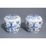 A pair of Chinese blue and white covered bowls with antiquities, 19th/20th C.