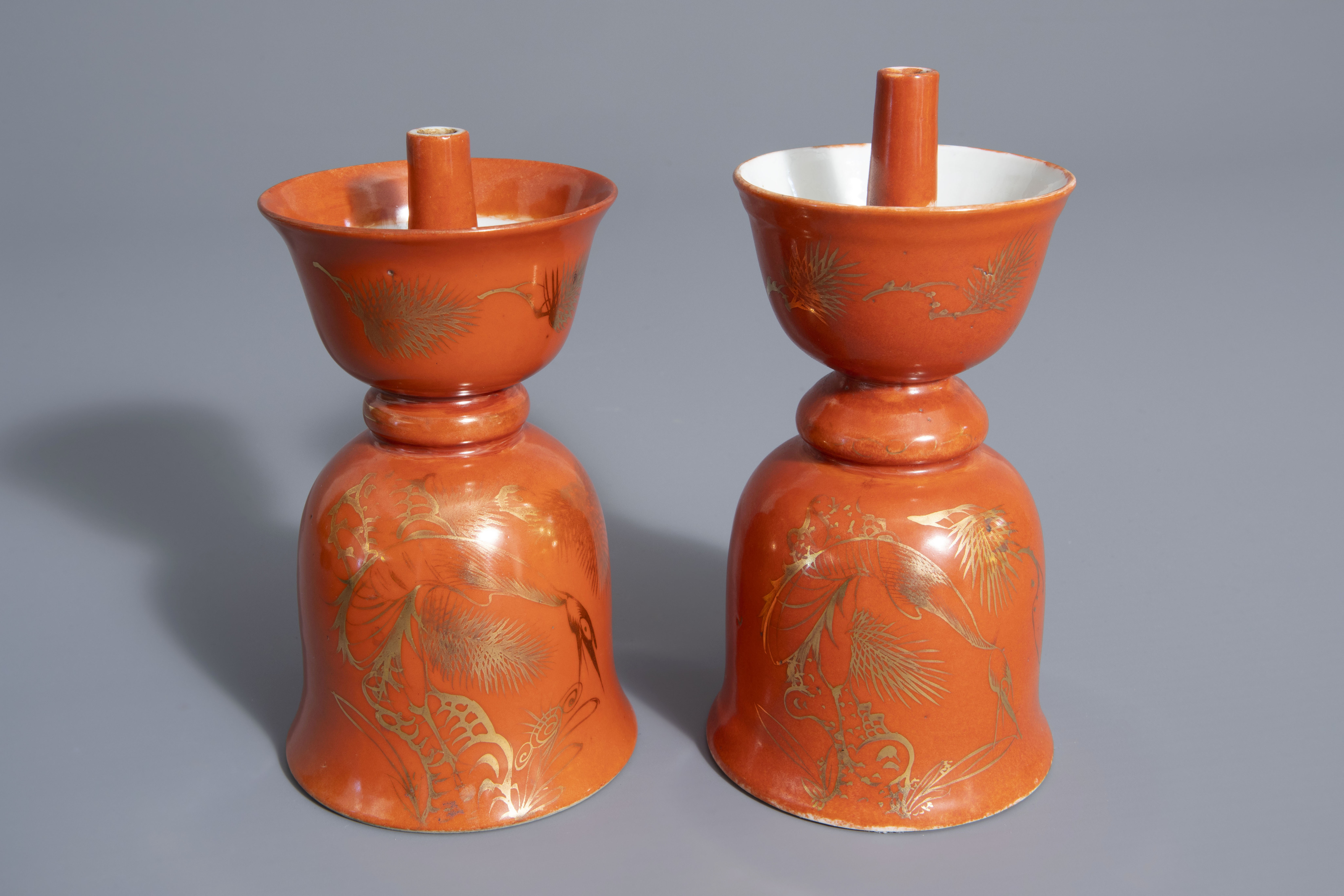 Two Chinese gilt decorated coral ground candlesticks, 19th/20th C.