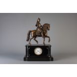 A black marble mantel clock with on top a patinated bronze crusader on his horse, France, 19th C.