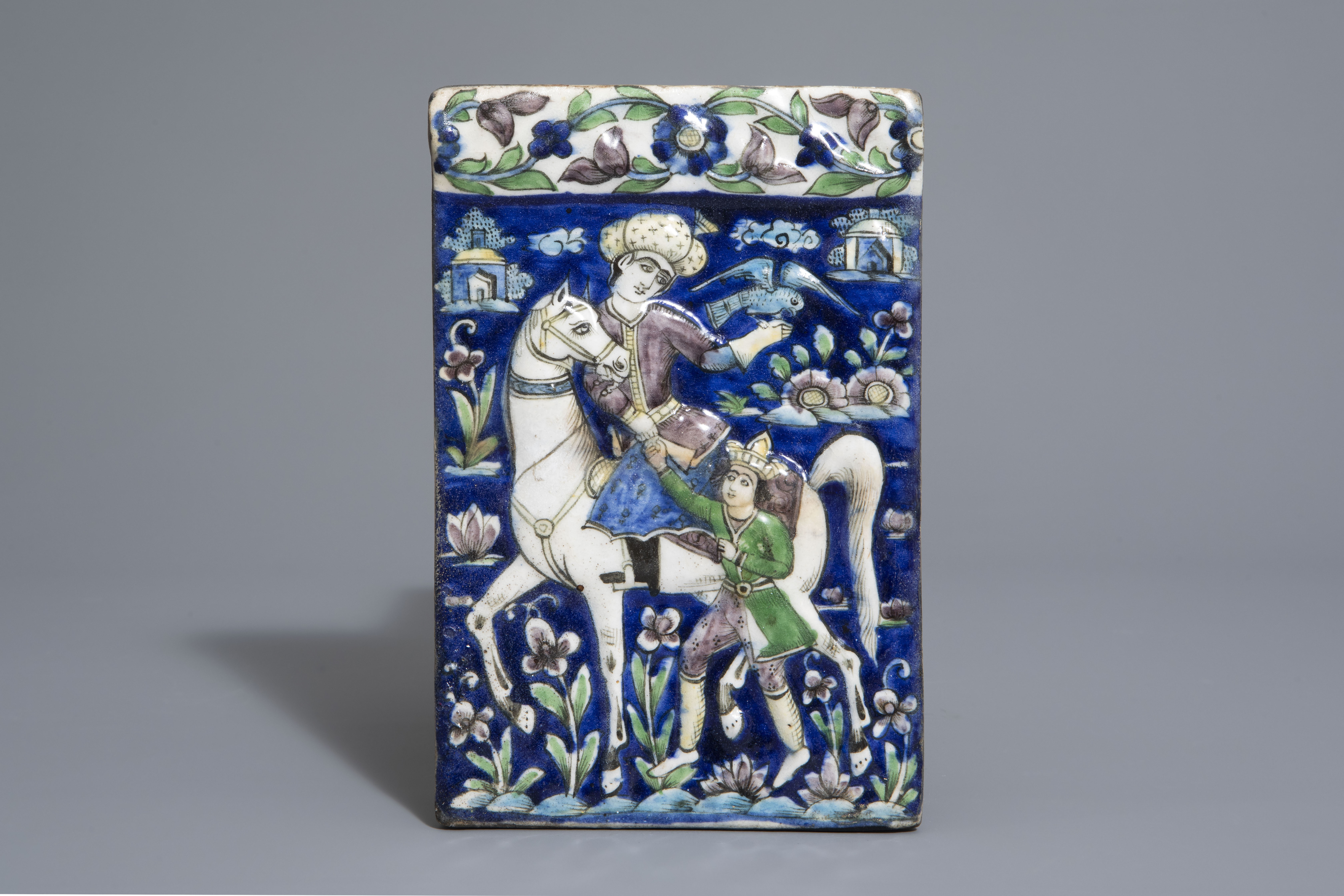 A rectangular Qajar relief moulded tile with a falconer on horseback, Iran, 19th C.