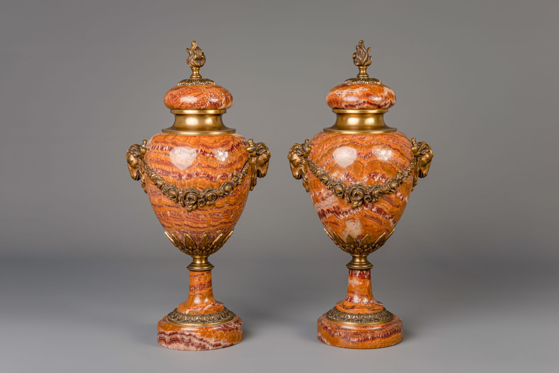 A pair of Neoclassical gilt bronze mounted Breccia Pernice marble urns, 19th/20th C.