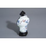 A Chinese blue, white and copper red wall vase with a bird among flowering branches, 19th/20th C.