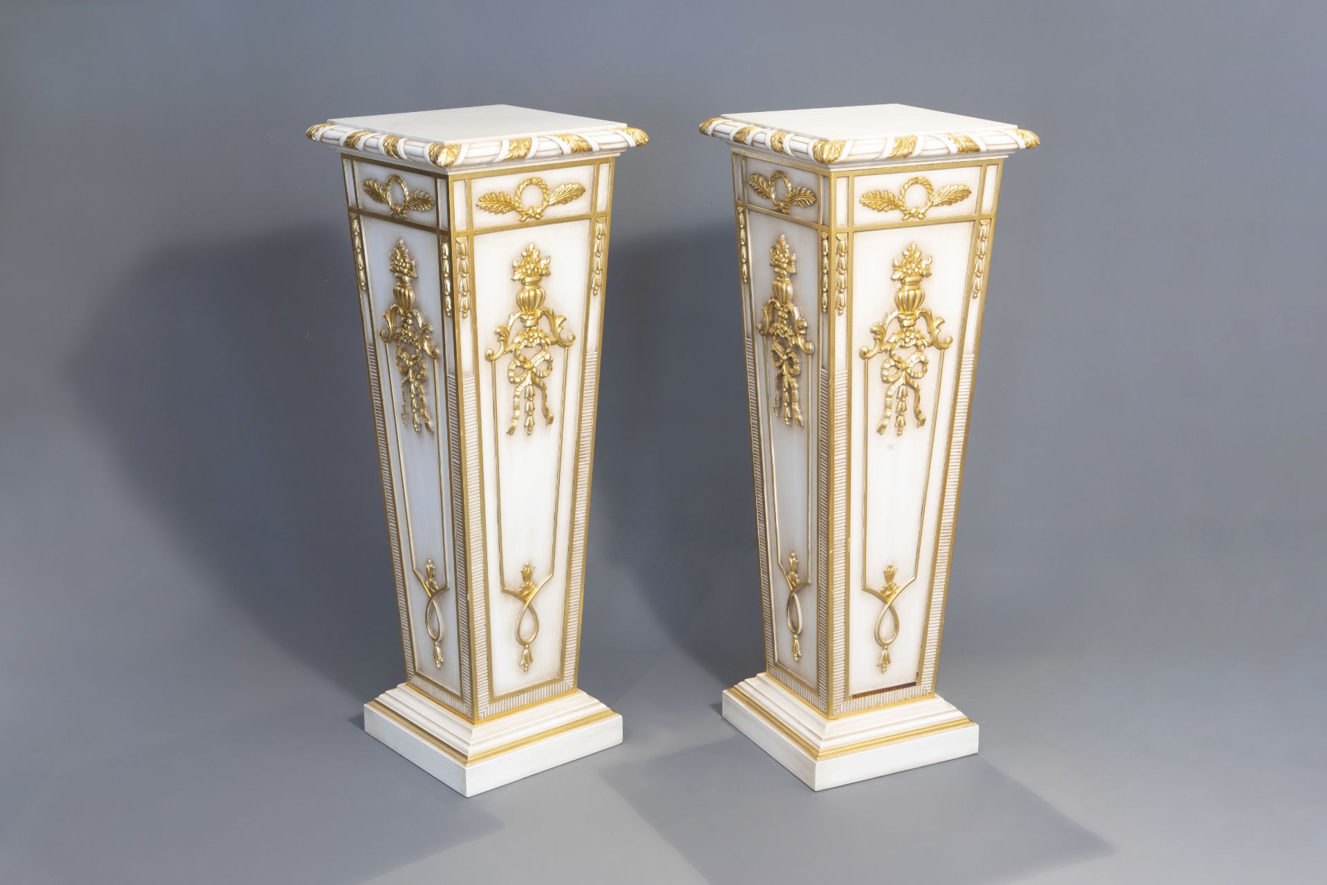 A pair of fine gilt and patinated wooden Empire style pedestals, presumably Italy, 20th C.