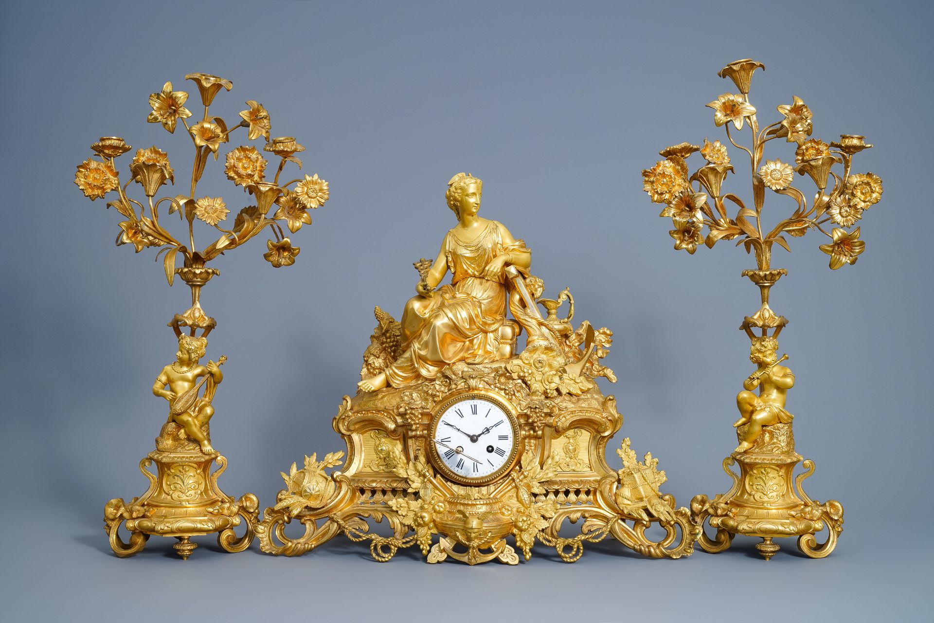 A French gilt bronze three-piece clock garniture with classical theme, 19th C.