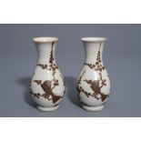 A pair of Chinese Cizhou style slip decorated vases with birds on blossoming branches, 19th C.