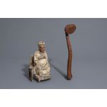 A Chinese carved wooden ruyi scepter and a painted wooden ancestor figure, 19th/20th C.