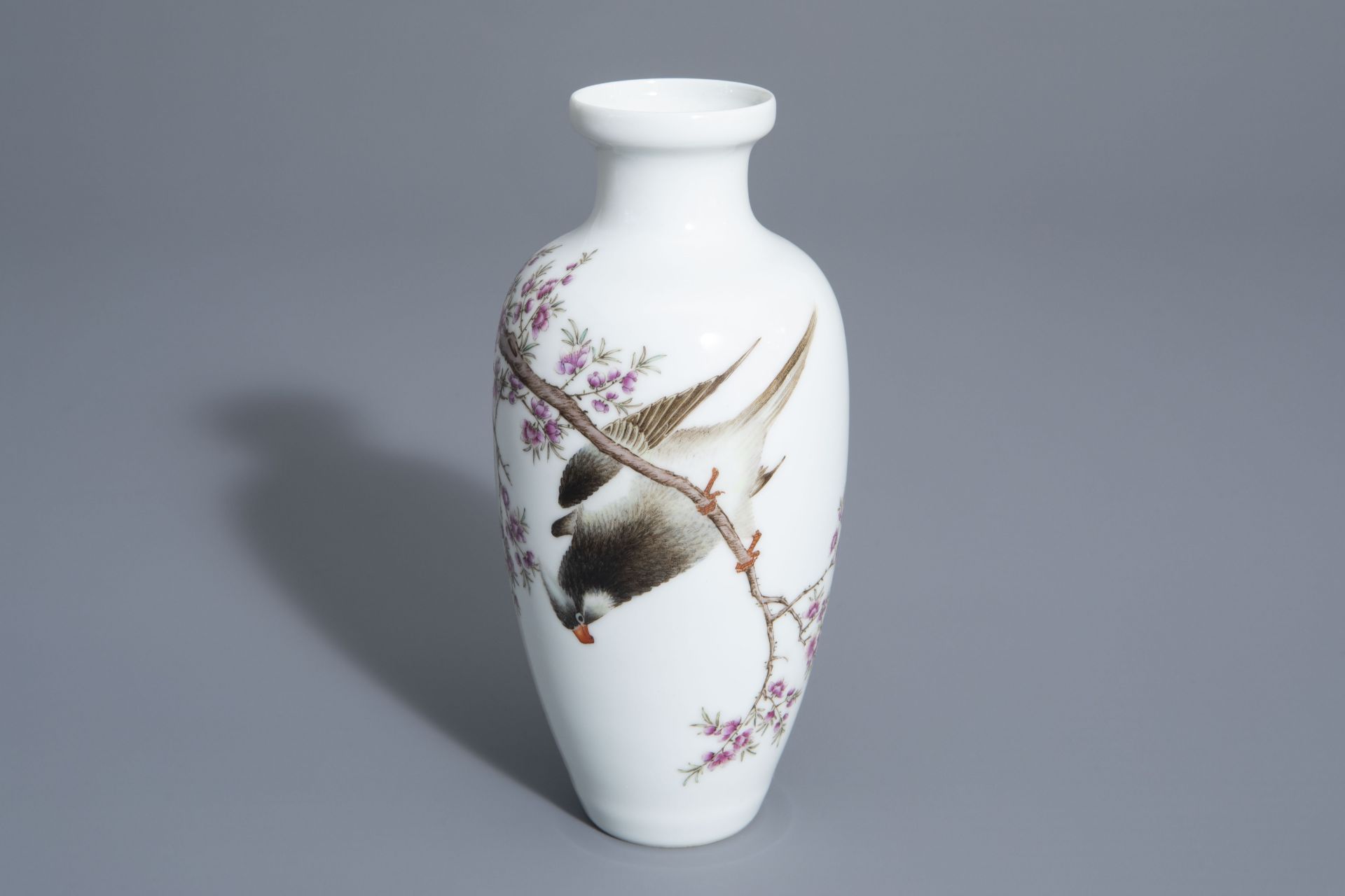 A Chinese famille rose vase with a bird among a flowering branch, 20th C.