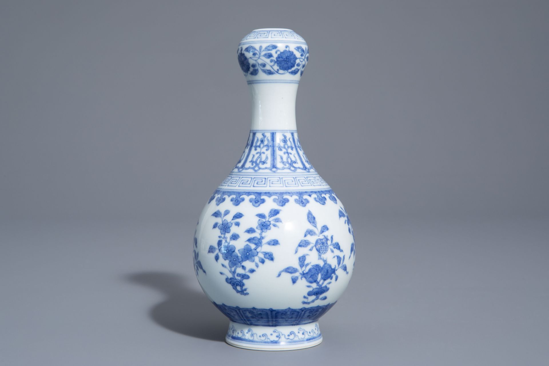 A Chinese blue and white garlic-head mouth vase with floral design, Qianlong mark, 20th C. - Image 3 of 7