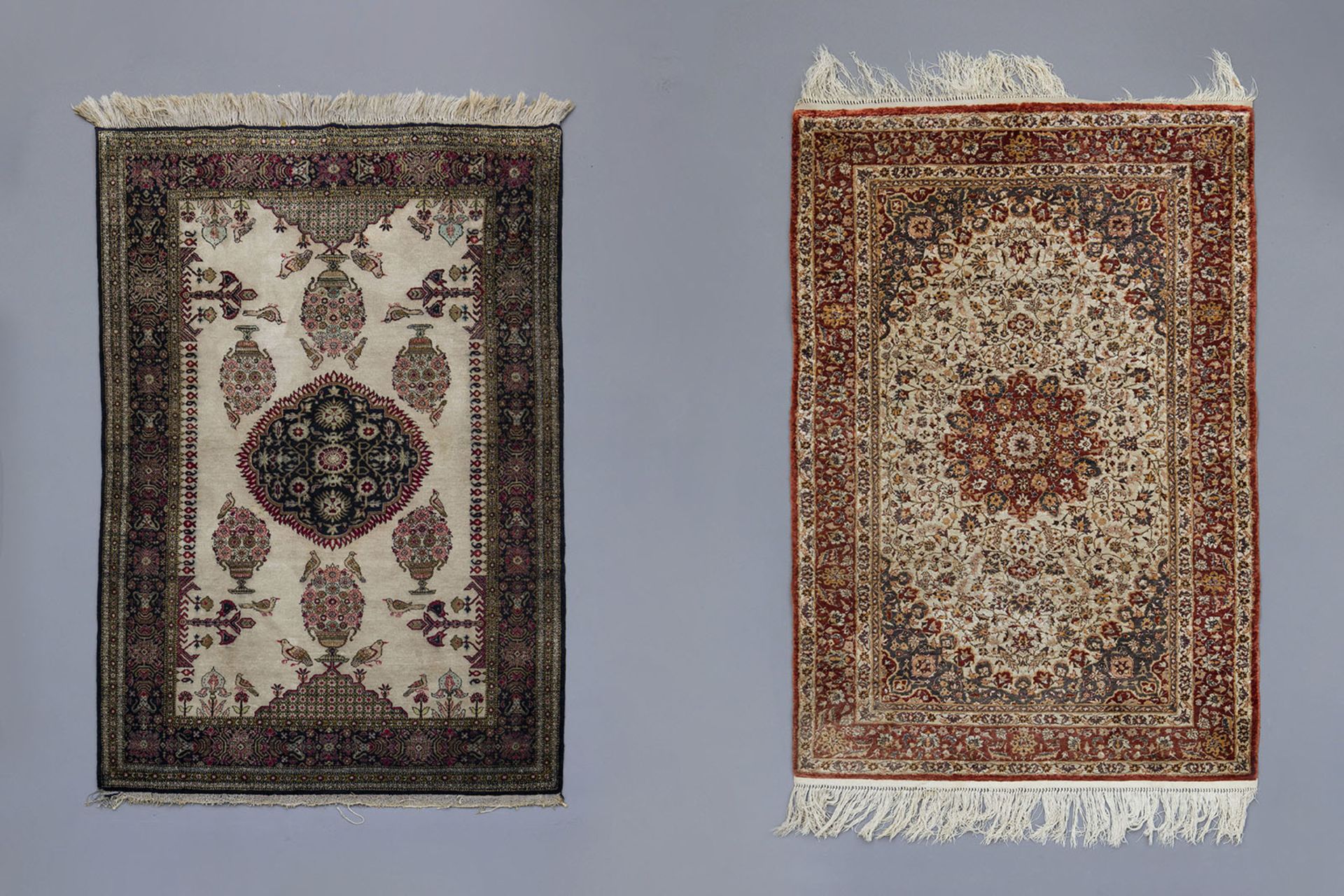 Two Oriental rugs with floral design, birds and a central medallion, silk on cotton, 20th C.