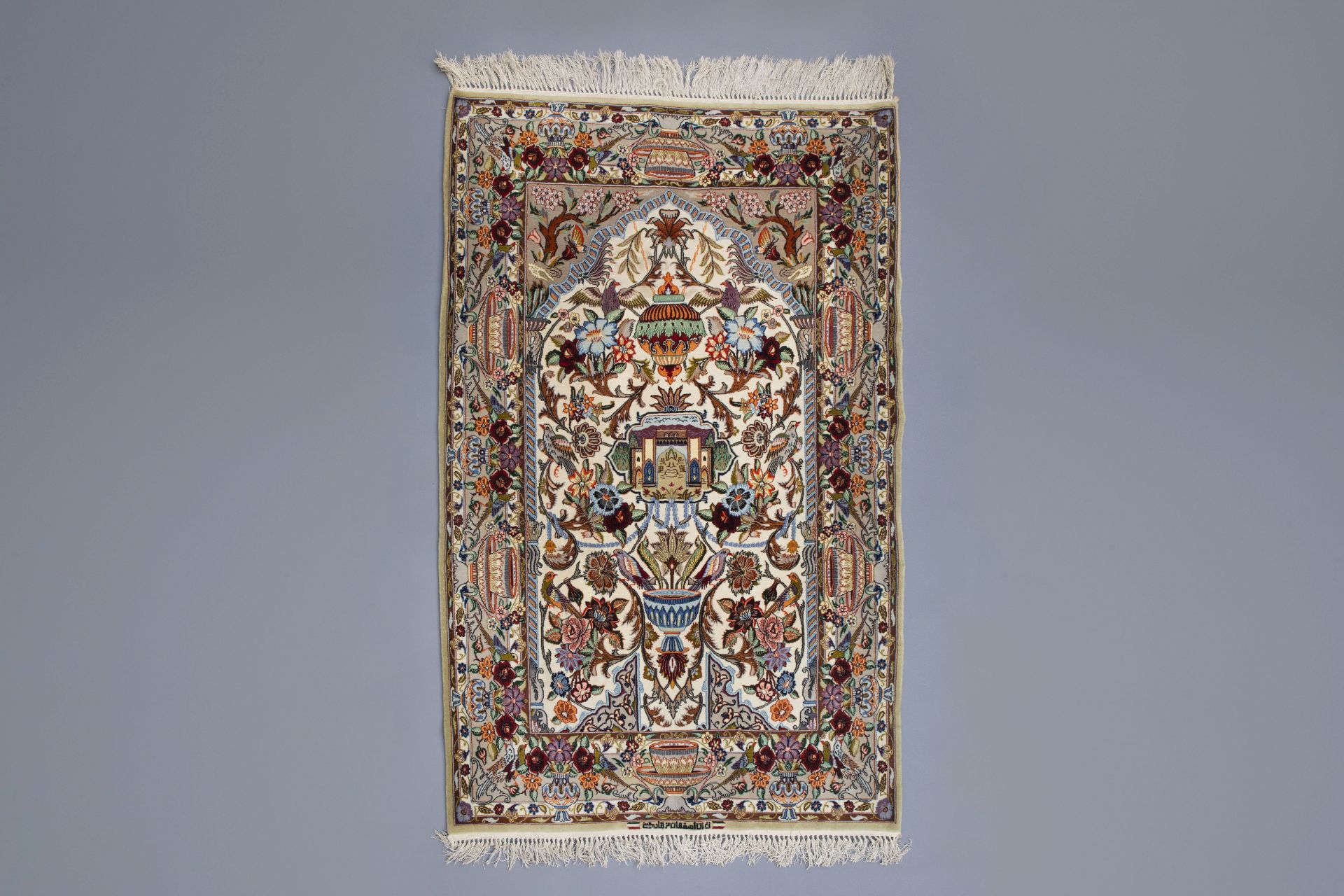 An Oriental prayer rug with birds, antiquities and floral design, Isfahan , 20th C.