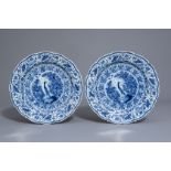 A pair of Dutch Delft blue and white chargers with a bird among blossoming branches, 18th C.