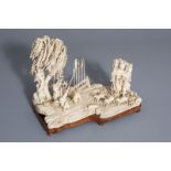 A Chinese ivory group: martial arts class, on wooden base, signed, second quarter of the 20th C.