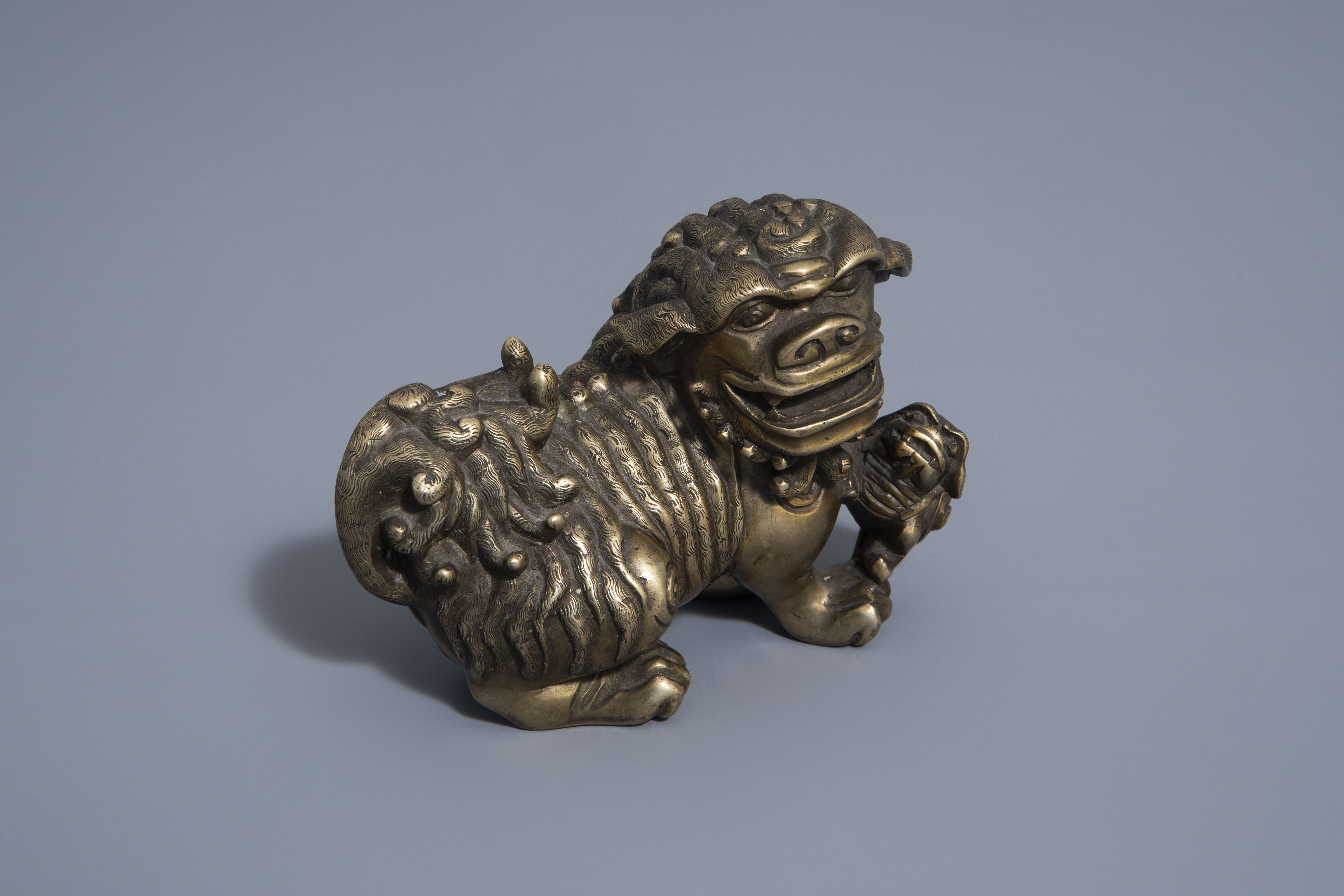 A Chinese bronze model of a Buddhist lion, late Qing