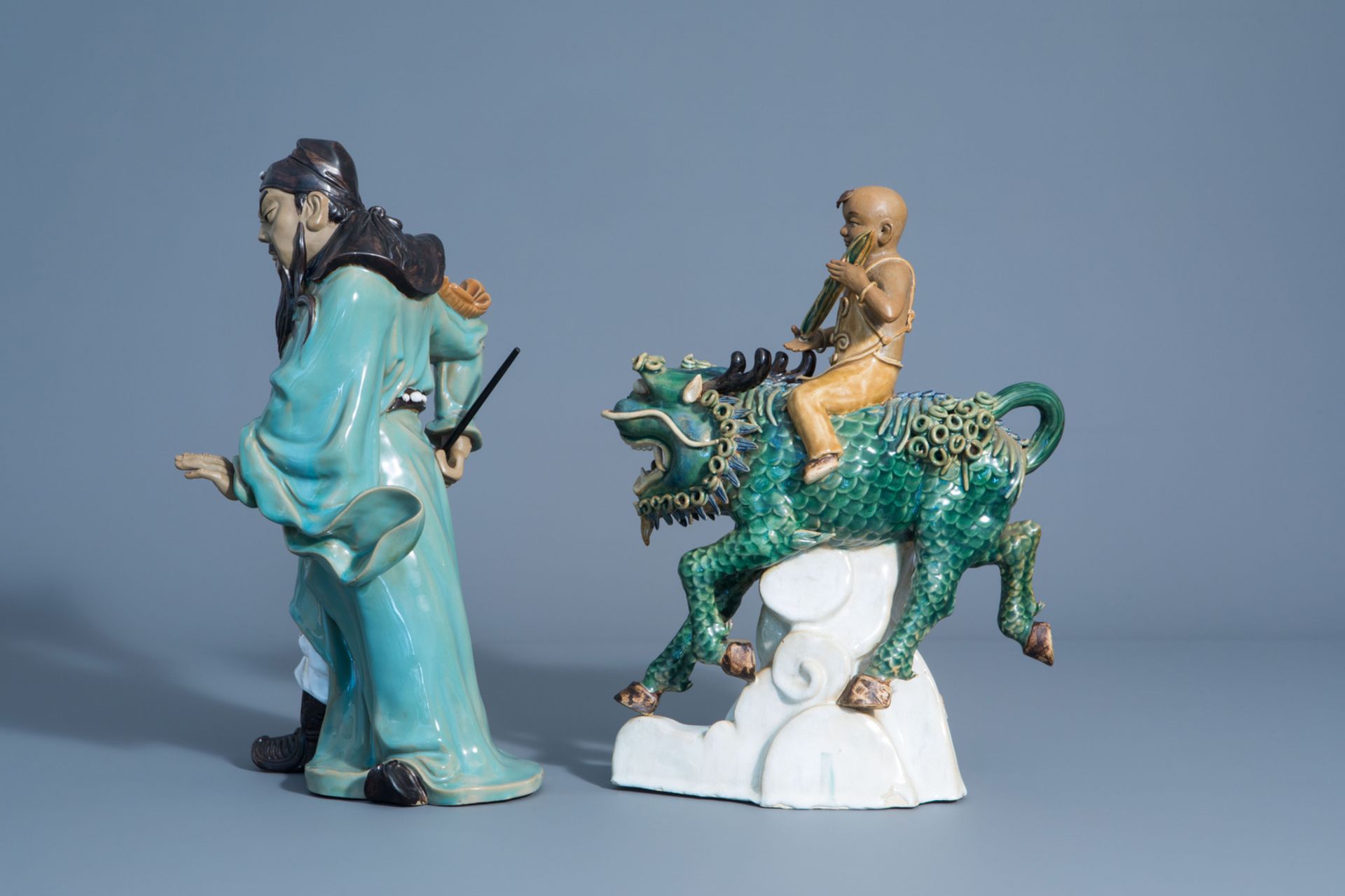 Two Chinese Shiwan pottery models of a warrior and a boy riding a Buddhist lion, 20th C. - Image 5 of 8