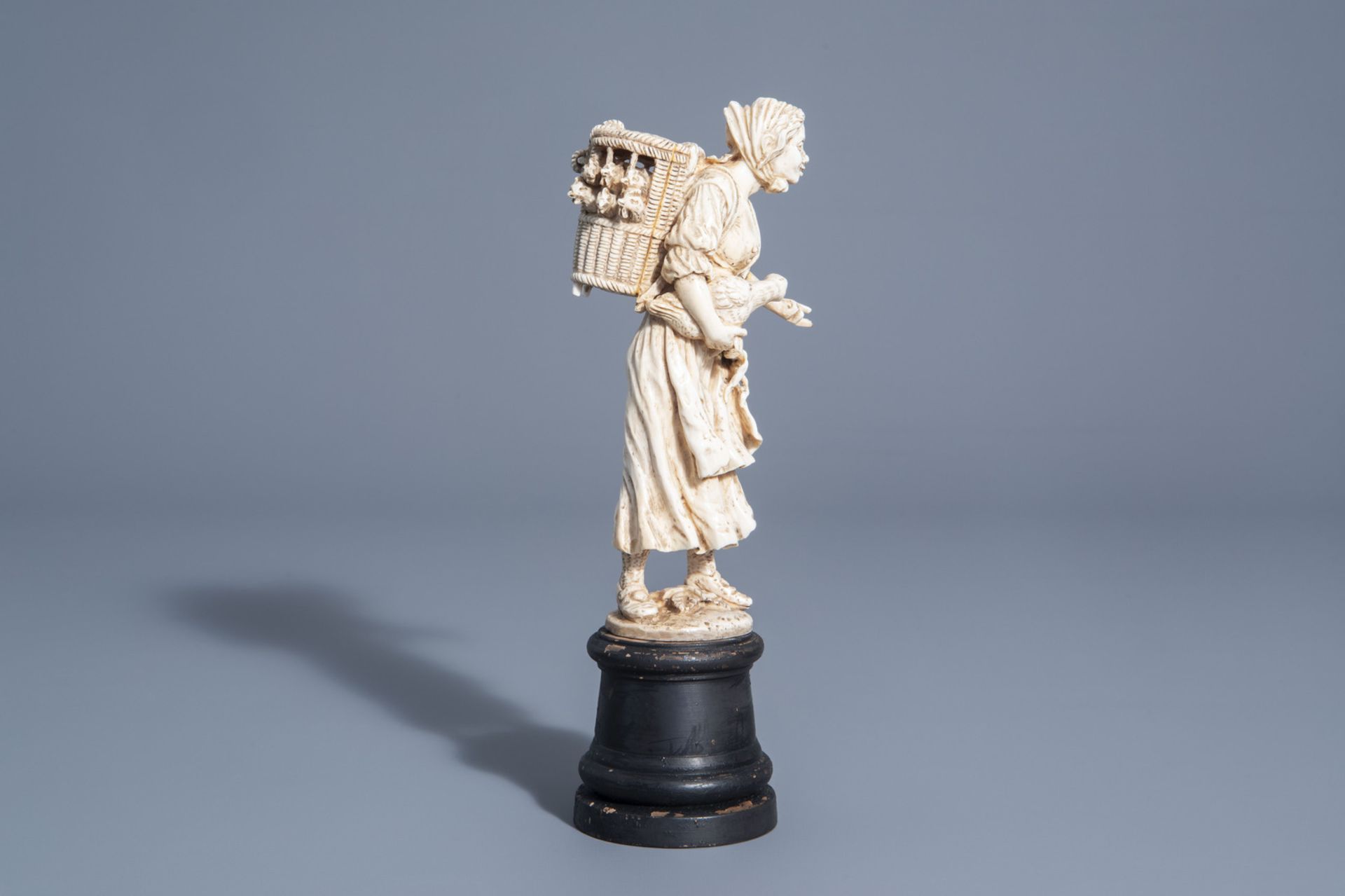 A carved ivory figure of a lady with poultry on wooden base, probably Dieppe, France, 19th C. - Image 3 of 7