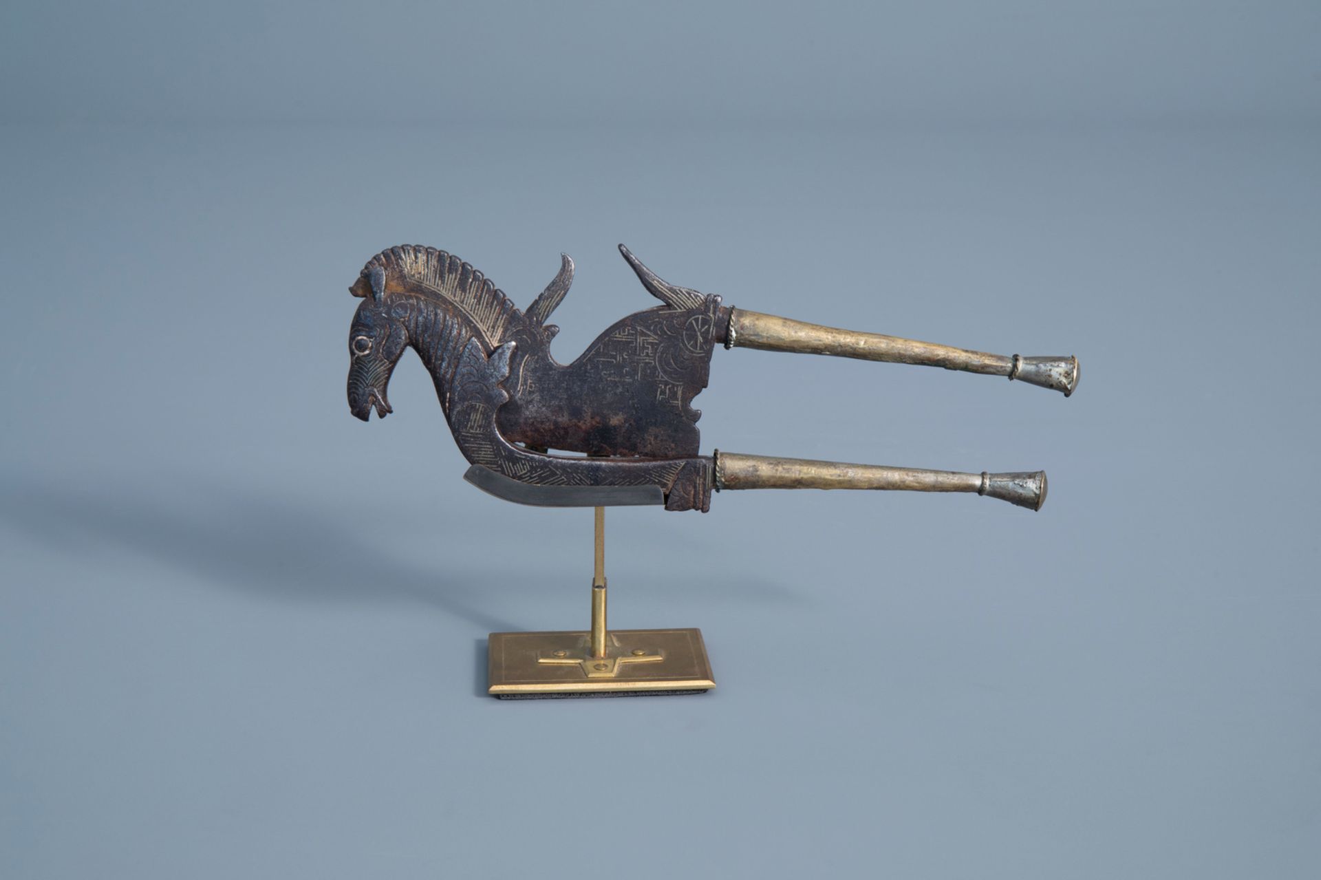 An inlaid iron and brass betel nut cutter in the shape of a horse, Indonesia, 19th C.