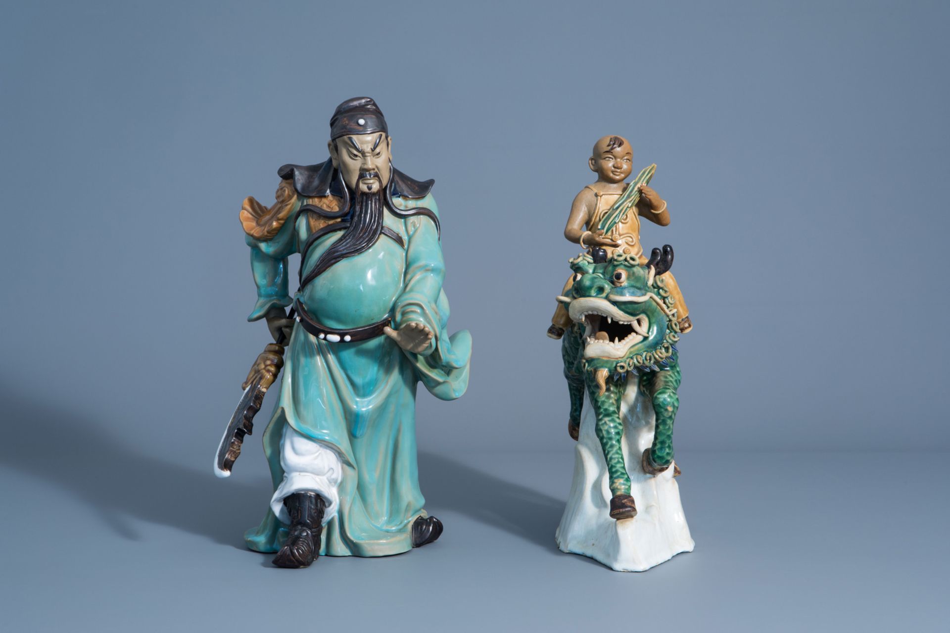 Two Chinese Shiwan pottery models of a warrior and a boy riding a Buddhist lion, 20th C. - Image 2 of 8