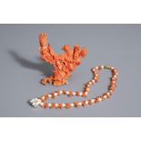 A Chinese carved red coral group of a lady with a child and a necklace with pearls, 19th/20th C.