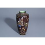 A Japanese cloisonnŽ vase with figures in a garden all around, 19th/20th C.
