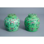 A pair of Chinese green ground famille rose jars and covers with floral design, 19th C.