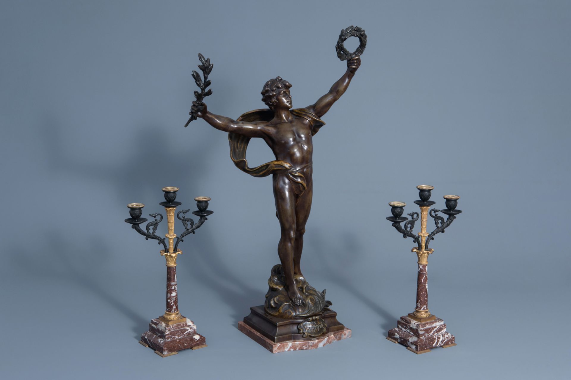 Louis Moreau (1883-1952): 'Le triomphe', patinated zamac and a pair of marble and bronze candelabra,