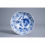 A Chinese blue and white plate with a tea ceremony and floral design, Kangxi mark and of the period