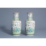 A pair of Chinese Canton famille rose vases with birds and butterflies among blossoms, 19thC.