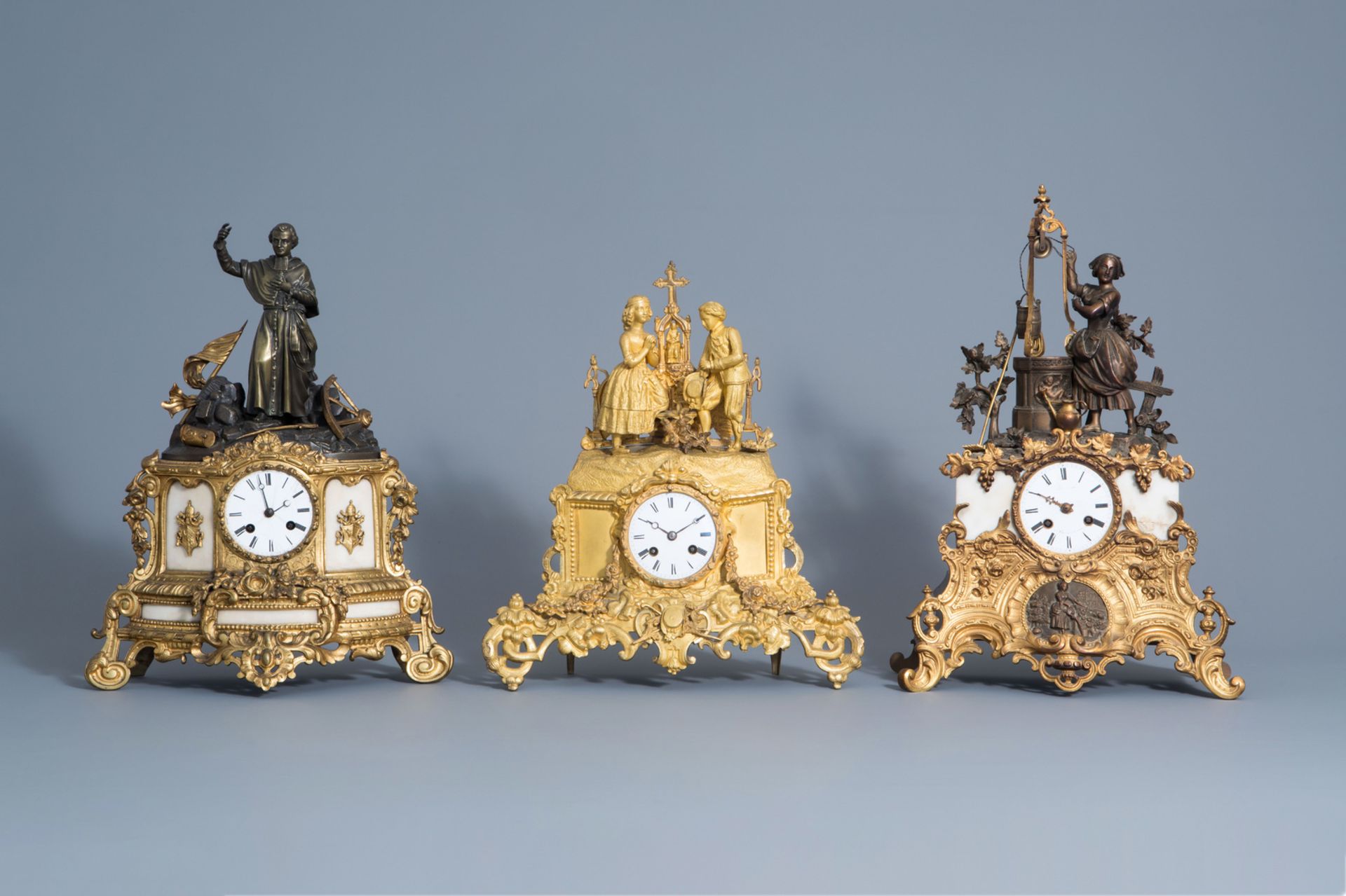 Three French gilt and patinated bronze romantic mantel clocks, 19th C.