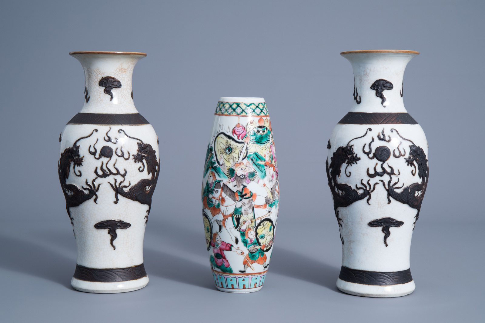 A pair of Chinese Nanking crackle glazed vases with a dragon and a famille rose vase with a warrior