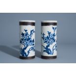 A pair of Chinese blue and white Nanking crackle glazed hat stands with floral design, 19th C.