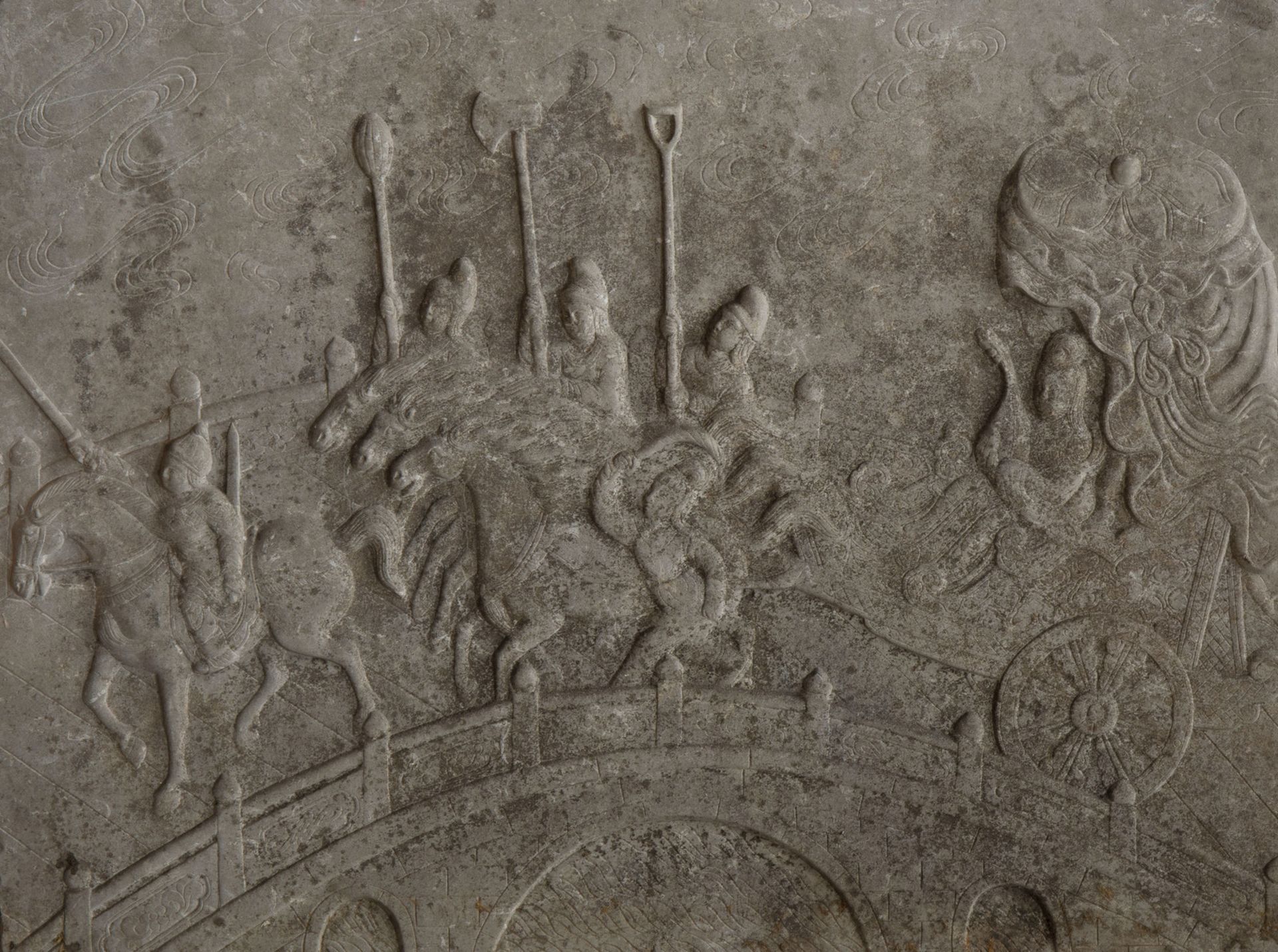 A Chinese carved stone bas-relief with a horse chariot on a bridge, 19th/20th C.