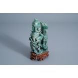 A Chinese green jade vase and cover with birds among blossoming branches on a wooden stand, 20th C.
