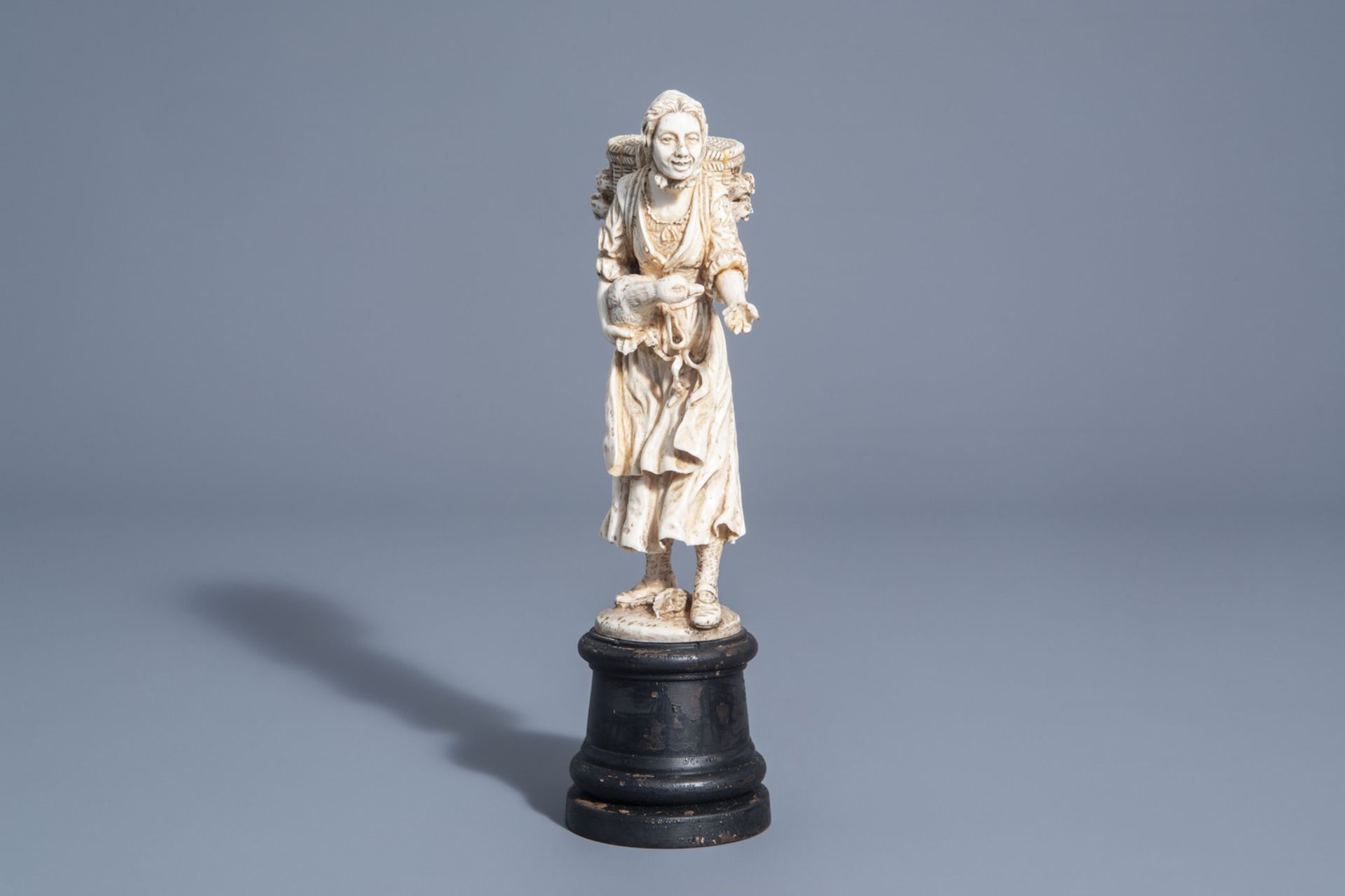 A carved ivory figure of a lady with poultry on wooden base, probably Dieppe, France, 19th C. - Image 2 of 7