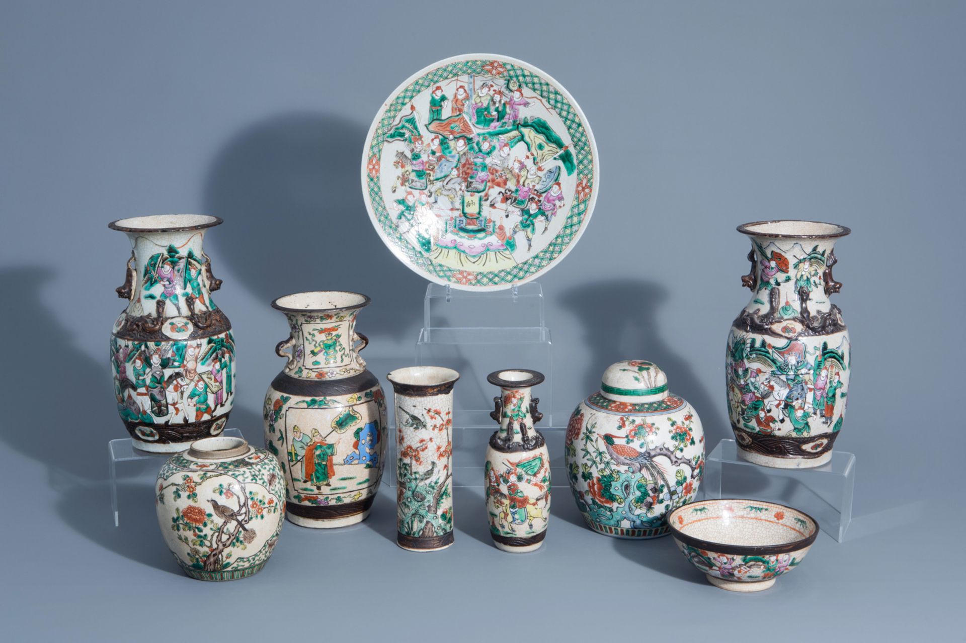 A varied collection of Chinese Nanking crackle glazed famille rose vases, ginger jars, a charger and