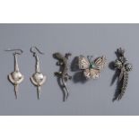 A varied collection of silver jewelery consisting of three brooches and a pair of earrings, 20th C.