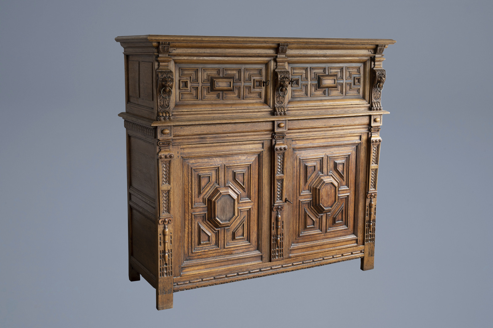 A Dutch wooden cupboard 'Zeeuwse kast' with geometric pattern and flanked by lions, 18th C.